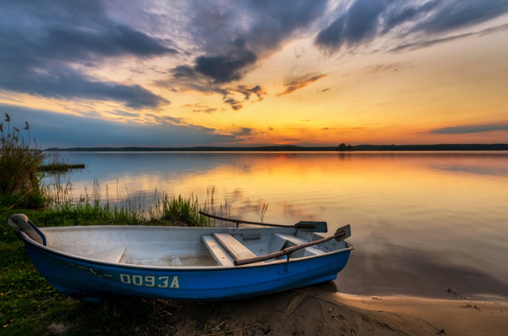 Złoty zachód – łódź na tle mazurskiego nieba