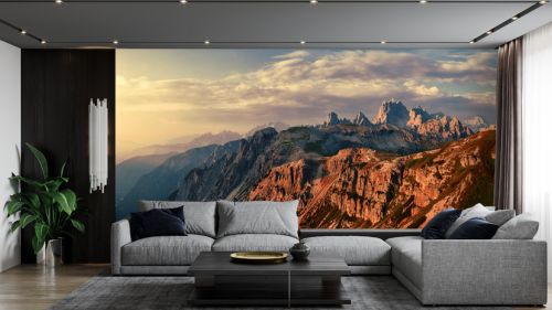 Wonderful Sunny Landscape of Dolomite Alps during sunrise. Panoramic view of famous Dolomites mountain peaks glowing in beautiful golden evening light at sunset in summer, South Tyrol, Italy.