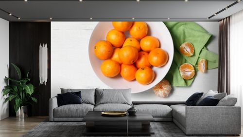 White bowl with fresh tangerines on white background