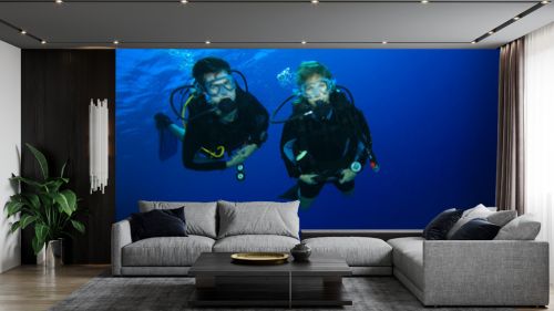 Couple scuba diving on a coral reef
