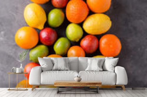 Citrus fruits on gray abstract background. Оrange, lemon, grapefruit, mandarin, lime. Mixed festive colorful tropical and citrus fruit. Healthy eating photo concept. Copyspace
