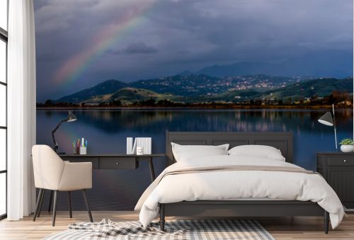 The rainbow is reflected in the waters of Lake Massaciuccoli, Lucca, Tuscany, Italy