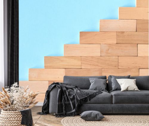Brown wooden blocks stairs shape idea on blue background composition.