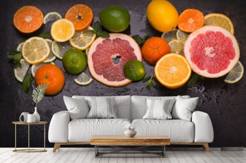 Citrus background. Fresh citrus fruits - Lemons, oranges, limes, grapefruits on wooden background.