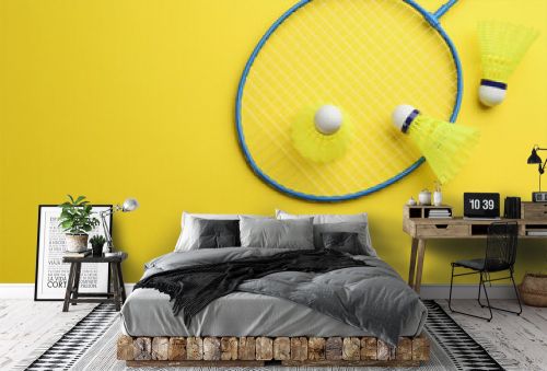 Badminton racket and shuttlecocks on yellow background, flat lay. Space for text