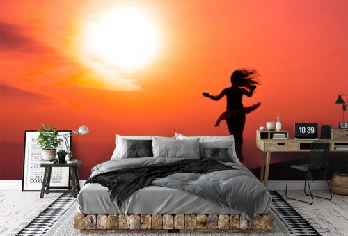 Ballerina in silhouette in a red sunset