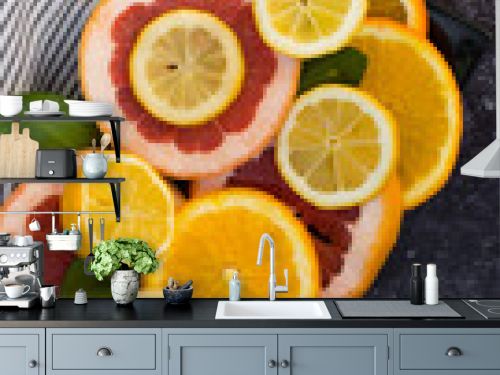 Colorful assortment of citrus fruits. Dark background
