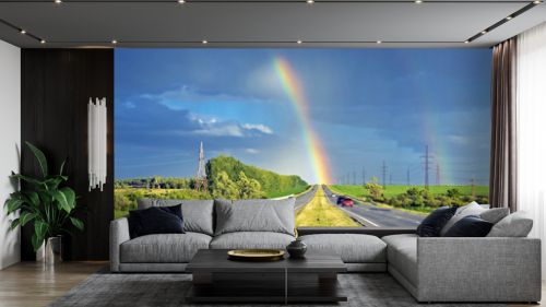 amazingly beautiful view of the rainbow on the horizon of the highway for cars
