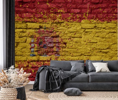 painted big national flag of spain on a massive old brick wall