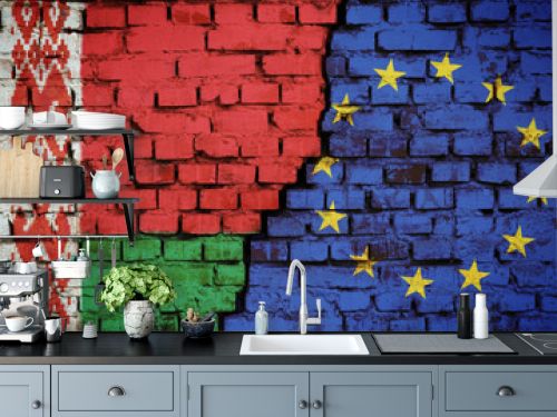 Brick wall with a flag of Belarus and European Union with a big crack in the middle. Concept of sanctions and political problems